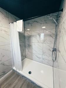 a bathroom with a shower with a shower curtain at Sky City Apartments in Coventry