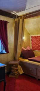 a room with a bed with a curtain and a window at Maisonette Elisabeth in Trier