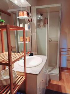 a bathroom with a white sink and a shower at Studio dans belle maison ancienne et jardin fermé in LʼÉtoile