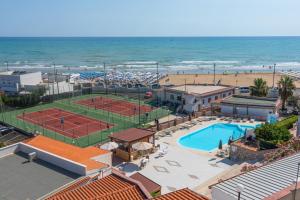an aerial view of a tennis court and the beach at Village La Canzone del Mare in Vieste