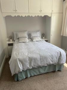 a bedroom with a large bed with white sheets and pillows at Bru Na Pairc B&B in Bantry