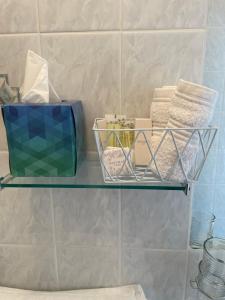 a glass shelf in a bathroom with towels at Bru Na Pairc B&B in Bantry