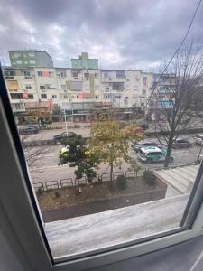 uma vista de um parque de estacionamento a partir de uma janela em Cozy Apartment em Tirana