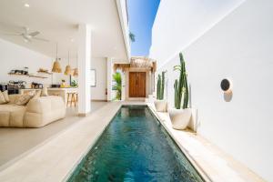 an infinity pool in the living room of a house at Villa Valentina - Luxury 2BR with Pool and Rooftop in Quiet Area of Canggu in Canggu