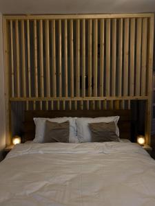 a bedroom with a large white bed with two lamps at B residence - Apartment A in Iaşi