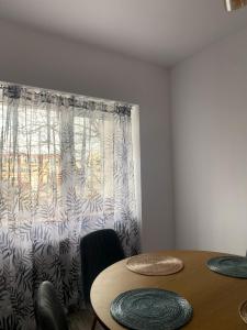 a dining room with a table and a window at B residence - Apartment A in Iaşi +9 photos