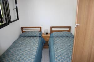 
A bed or beds in a room at Pellegrino Village
