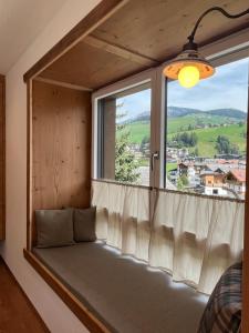 a window seat in a room with a view at Ciasa Valiares in San Vigilio Di Marebbe