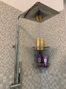 a shower stall with three shelves in a bathroom at Apartment+garage near Novegro Exhibition/Linate in Segrate