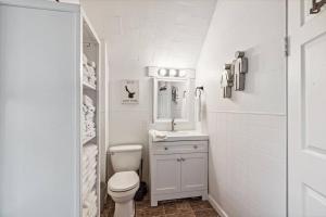 a white bathroom with a toilet and a sink at White House Bungalow in Bay City +25 photos