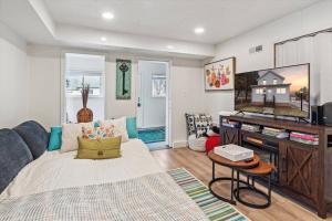 a living room with a couch and a tv at White House Bungalow in Bay City