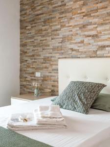 En eller flere senge i et værelse på “Sui tetti di Pietra” Appartamento Centro Storico