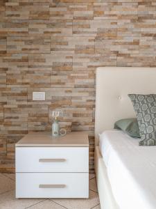 En eller flere senge i et værelse på “Sui tetti di Pietra” Appartamento Centro Storico