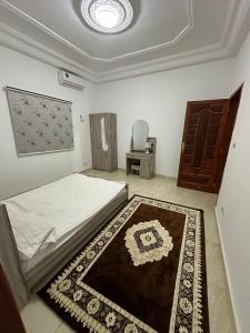 a bedroom with a bed and a table and a chair at La cave aux variétés in Nouakchott