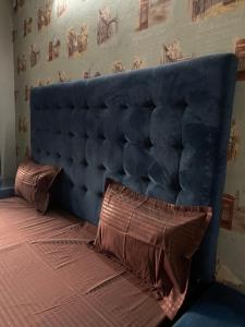 a blue headboard of a bed in a room at Urban Oasis in Zirakpur