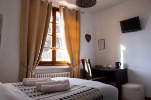Postel nebo postele na pokoji v ubytování Hôtel Le Tivoli