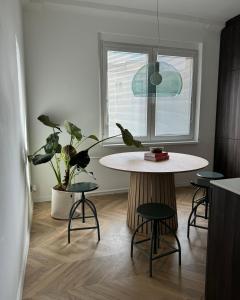 a kitchen with a table with chairs and a plant at Kukučínova apartment in Bratislava