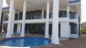 a large building with a pool in front of it at The Palace in Izinga Estate Umhlanga in Durban