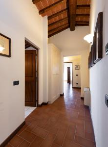 a hallway with a tile floor and a wooden ceiling at Ranuccio Apartment - Dimora di Fulignano in San Gimignano