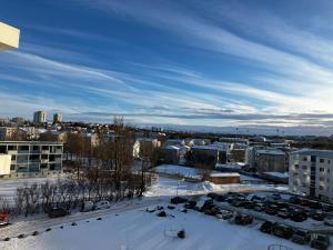 a view of a city in the snow at Private room in a shared apartment with amazing view in Reykjavík