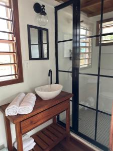 a bathroom with a sink and a glass shower at Belizima Eco Resort in Sarteneja