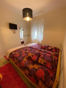 a bedroom with a bed with a colorful comforter at River Place in Porto
