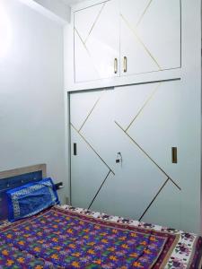 a bedroom with a bed and a white cabinet at Kishore villa fully furnished house in Jaipur