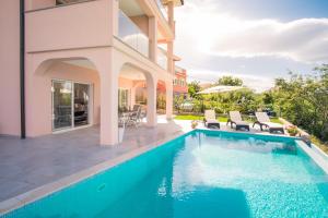 a swimming pool in the backyard of a house at Apartment with a private pool, enchanting view, beach - by Traveler tourist agency ID 2122 in Vrbnik