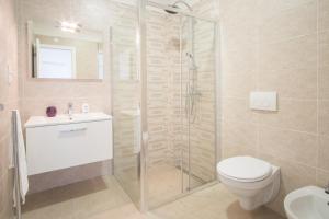 a bathroom with a shower and a toilet and a sink at Apartment with a private pool, enchanting view, beach - by Traveler tourist agency ID 2122 in Vrbnik +26 photos