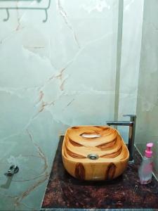 a wooden toilet seat sitting on a counter in a bathroom at Kishore villa fully furnished house in Jaipur
