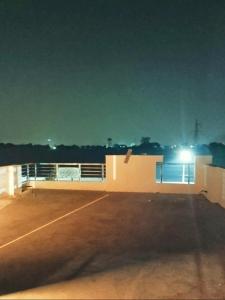 a parking lot with a tennis court at night at Kishore villa fully furnished house in Jaipur