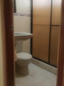 a bathroom with a toilet and a sink at Quinta Alfa in Jesús María