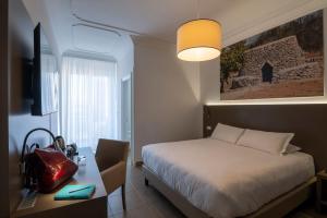 Postel nebo postele na pokoji v ubytování Hotel Delle Palme