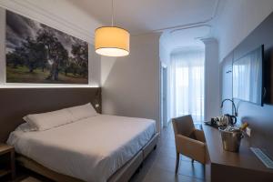 Postel nebo postele na pokoji v ubytování Hotel Delle Palme