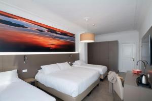 Postel nebo postele na pokoji v ubytování Hotel Delle Palme