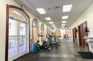 a gym with treadmills and exercise bikes in a room at Villas at Regal Palms-4 Bedroom3.5 bath Townhouse in Davenport