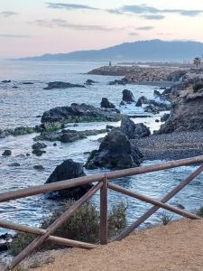 a wooden fence on the beach near the water at Villaricos in Villaricos