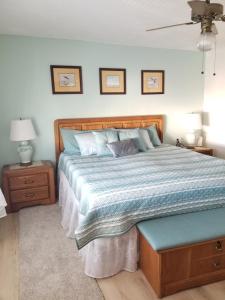 a bedroom with a large bed with a blue comforter at Island Life in Saint Augustine Beach