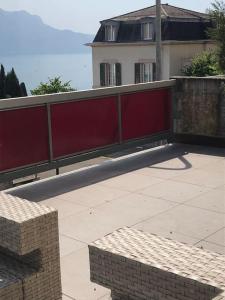 a large red fence in front of a house at Vue sur lac et proche du centre in Montreux