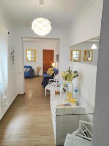 a living room with a kitchen and a living room with a couch at Céntrico apartamento con terraza y WIFI in Ronda