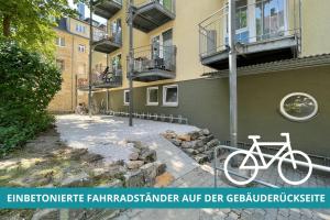 a white bike parked next to a building at Apt Wahnfried Nr1 - Cityapartment mit Küche, Duschbad, Balkon, Parkplatz - zentral aber ruhig in Bayreuth