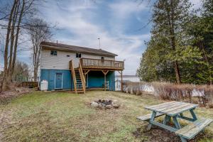 a house with a deck and a picnic table at Lakehouse chalet on Sky Lake Ontario 5 bedrooms in Red Bay