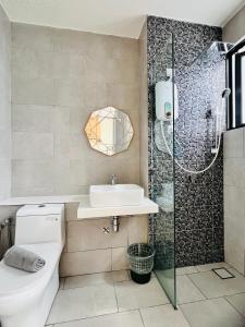 a bathroom with a toilet and a sink and a shower at The Shore Maison Life 小居屋 in Kota Kinabalu