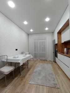 a dining room with a table and a kitchen at 2-х комнатная квартира Гоголя 106 in Semey +6 photos