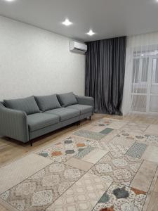 a living room with a couch and a rug at 2-х комнатная квартира in Semey