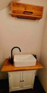 ein weißes Waschbecken auf einer Holztheke im Bad in der Unterkunft stilvolles und komfortables Chalet mit Weitblick in Ebenfeld