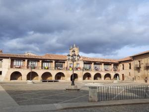 a large building with a clock tower in a courtyard at Villa- Belen in Santo Domingo de la Calzada