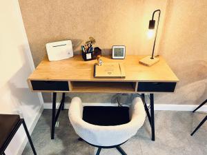 a desk with a chair and a laptop on it at Gemütliches Seeapartment am Berg in Arrach