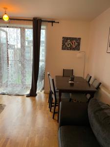 a living room with a table and a couch at Two bed fully furnished apt in Dublin