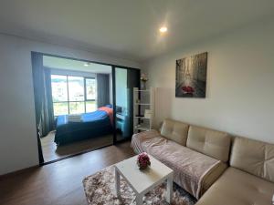 a living room with a couch and a bed at 1 bedroom Centrio Condominium Phuket Near Central Festival in Phuket town in Phuket Town +46 photos